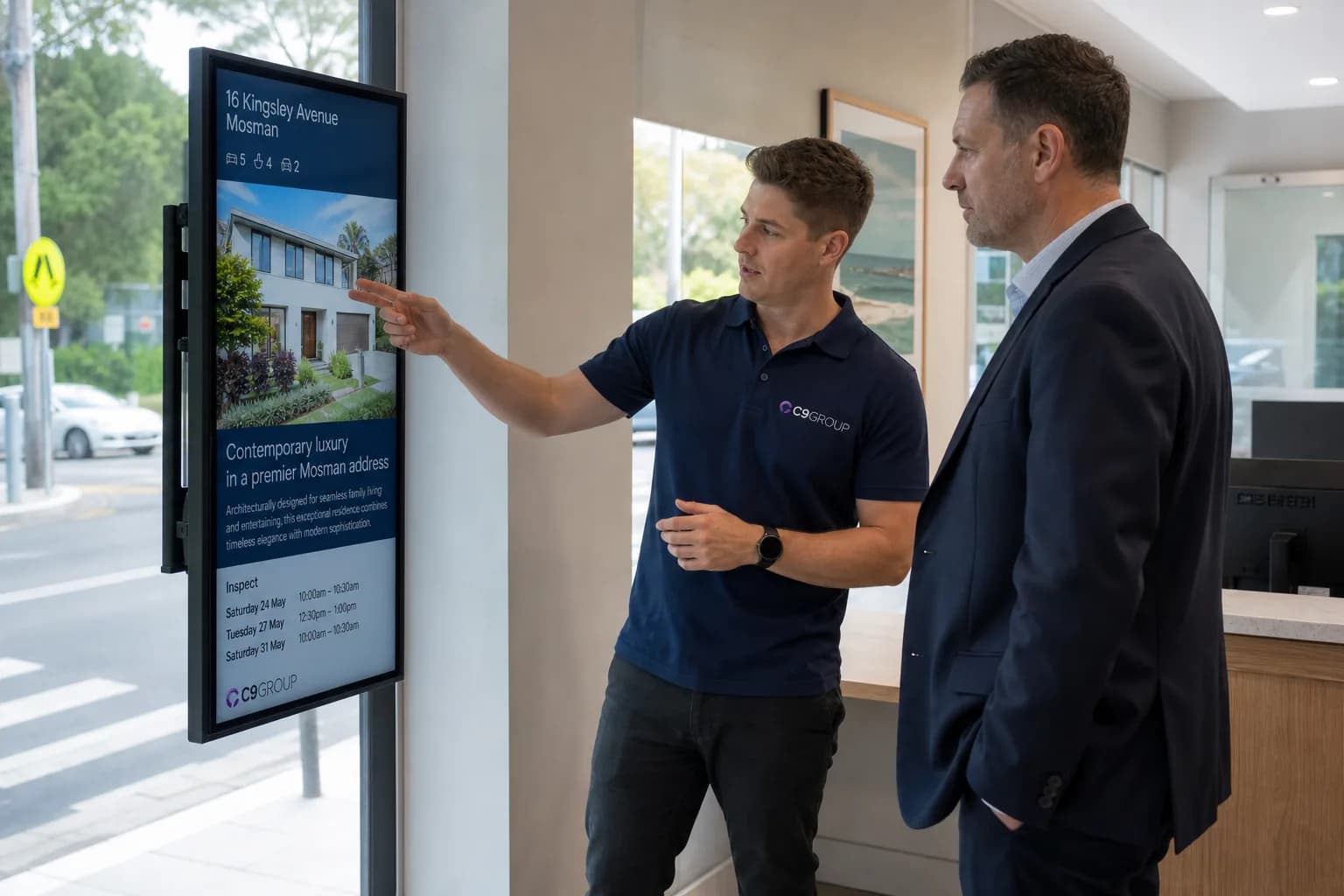 C9 GROUP specialist reviewing a slim real estate signage rollout with an agency manager