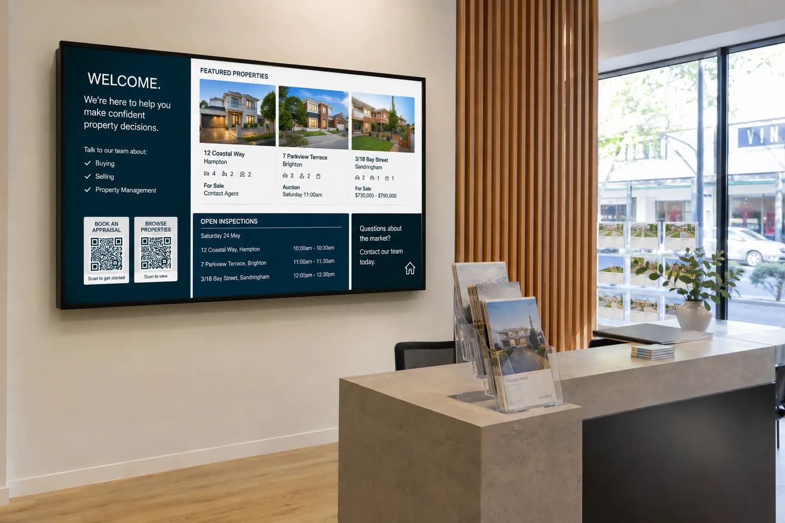 Real estate agency reception screen showing featured listings and appraisal prompts