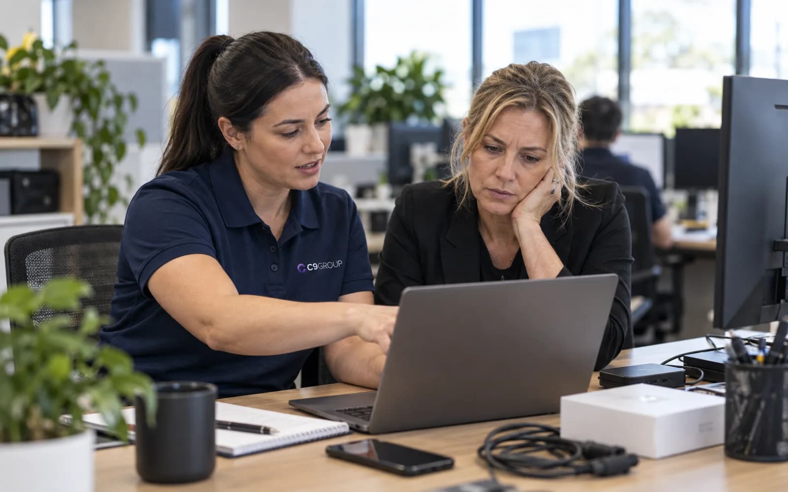 C9 GROUP managed IT specialist working beside a business owner in a modern Australian office