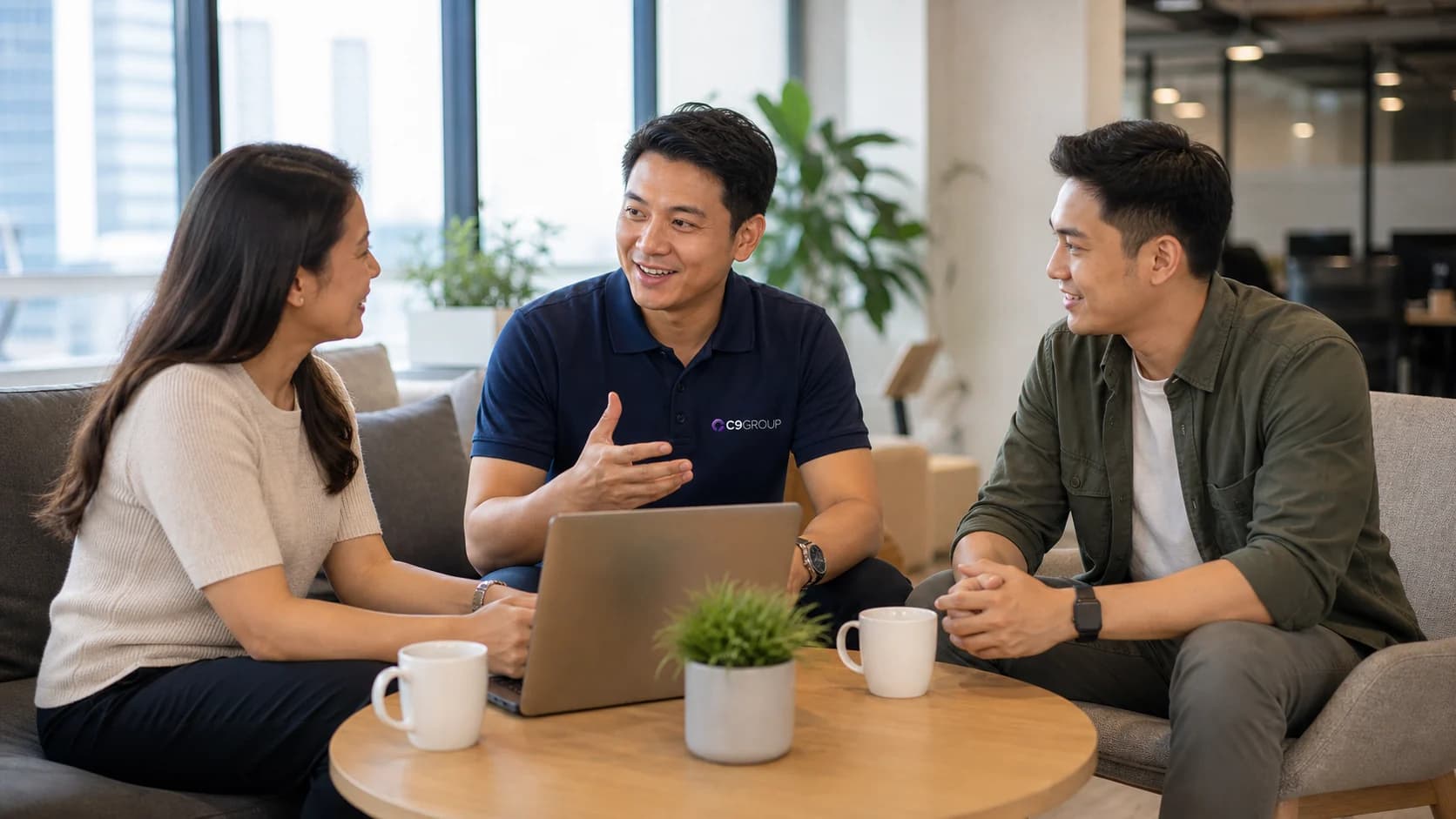 Filipino C9 workforce manager speaking with remote professionals in a natural office setting